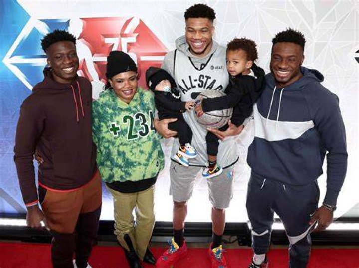 Giannis and Liam Charles Antetokounmpo poses with son on his lap