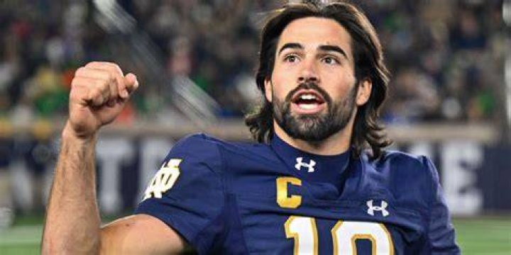 Notre Dame QB Sam Hartman is wearing a necklace with part of his